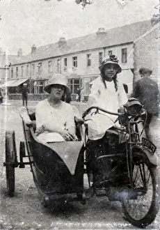 Whites Prints: Two ladies on veteran motorcycle combination in street