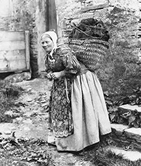 Peat Prints: Lady carrying peat and knitting, Shetland Isles