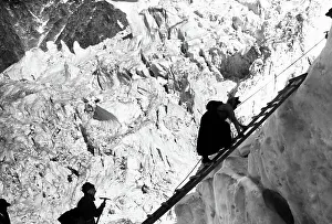 Alps Prints: Lady climber crossing a crevasse in the Alps