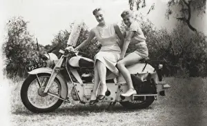 Lady and girl on veteran motorcycle