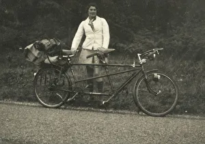 Images Dated 18th March 2021: A lady kitted out for a cycling trip in warm coat and long socks standing alongside a