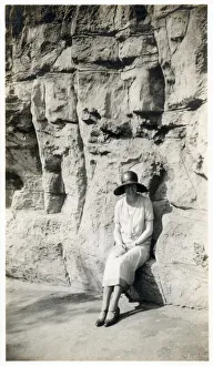 Candid Prints: Lady sitting on a natural seat beneath a rock cliff