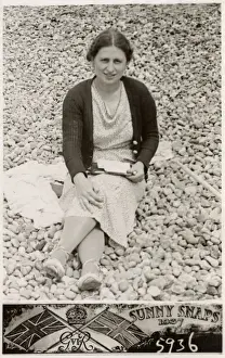 Writes Prints: Lady on a south coast beach writing postcards to family