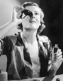 Routine Prints: Lady Using Eyebath / Photo