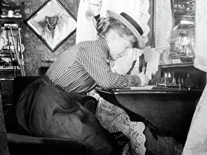 Lady writing at her desk, early 1900s