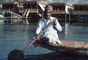 Squatting Collection: Lake Dal, Srinagar, Kashmir - a man paddling boat