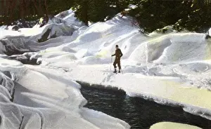 Lake Placid, N. Y. USA - Skier pauses by Winter Brook