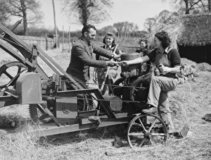 <b class=qtipBold><figcaption>Land Girls WWII</figcaption></b><br>A Land Girl being given the keys to a combine harvester while working on a farm during World War II<br><em>© Mary Evans/Robert Hunt Collectio</em> Land Girls WWII