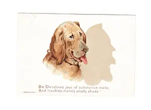Large dog casting a shadow on a Christmas card