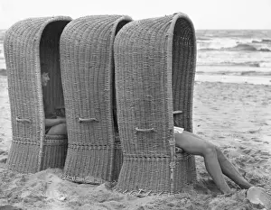 Shade Prints: Three large woven beach chairs at the seaside