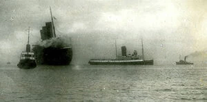 Burned Collection: L'Atlantique liner towed into Cherbourg harbour