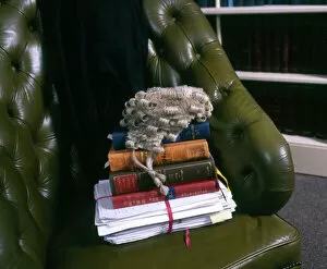 Office Gallery: Lawyers books, brief and wig in a leather chair