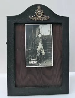 Images Dated 21st November 2011: Leather photograph frame and badge of the Royal Artillery