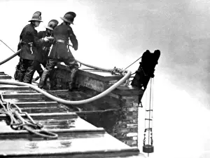 Calls Prints: LFB firefighters working on a roof at a warehouse fire