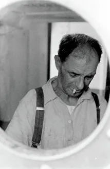 Braces Prints: Life on a North Sea trawler - man viewed through porthole. Date: 1960s