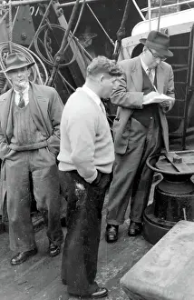 Admin Prints: Life on a North Sea trawler - three men on deck in ordinary clothes