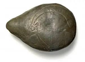 Paleolithic Prints: Limestone lamp with ibex carved on back