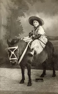 Little boy in cowboy costume in studio photo