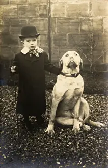 Gravel Prints: Little boy with large bulldog in a garden, France