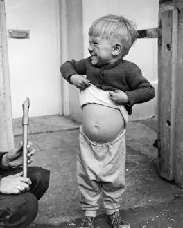 Stomach Gallery: Little boy lifts his jumper, Balham, SW London