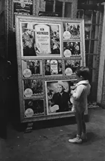Iberia Prints: Little boy looking at movie display, New Iberia, Louisiana