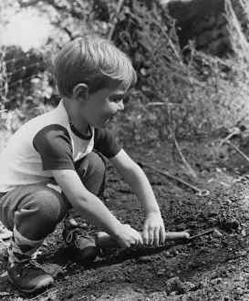 Trowel Prints: Little boy playing in a garden