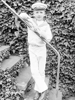 Little boy in a sailor suit in a garden, Mid Wales