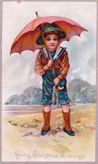 Little boy in sailor suit at the seaside on a Christmas card