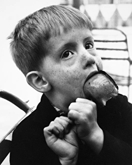 Toffee Gallery: Little boy with toffee apple, Balham, SW London