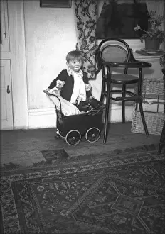 Little boy with a toy pram