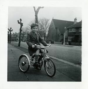 Little boy on a tricycle in a suburban street