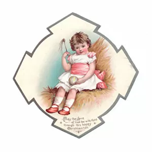 Little girl with ball on a medallion-shaped Christmas card