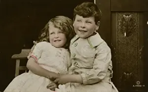 Little girl and boy sitting side by side
