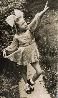 Images Dated 31st March 2017: Little girl in costume, posing on a garden path