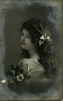 Little girl with dark hair and flowers