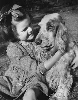 Little girl and dog in the garden