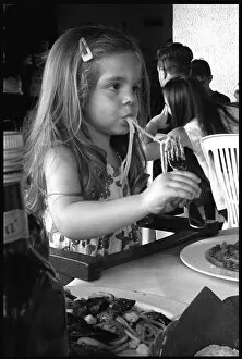 Little girl eating spaghetti, Italy