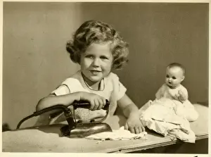 Ironing Prints: Little girl ironing her dolls clothes