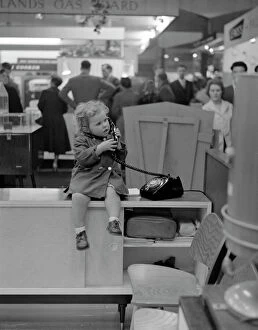 Images Dated 4th December 2009: Little Girl on the phone at a Trade Show