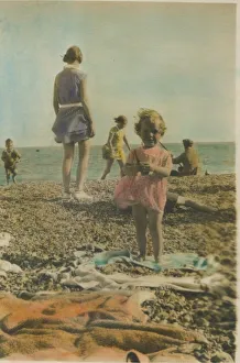 A little girl pictured playing on the beach at Bognor Regis, 1920s. Date: 1920s A little girl pictured playing on the beach at Bognor Regis, 1920s. Date: 1920s