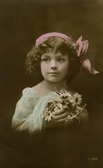Little girl in pink, blue and white with flowers