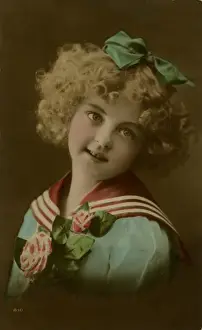 Little girl in sailor suit, with flowers