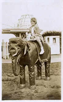 Little girl and her toy dog ride a model Elephant - Margate