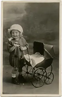 Little girl with toy pram