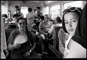 Little girl woman with fan on Tram, Valencia, Spain
