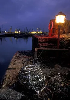 Mixed Gallery: Lobster pot lit by harbour light at night, Newlyn, Cornwall