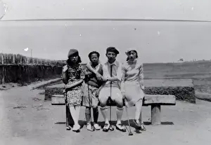 Four local people on a golf course in the Far East