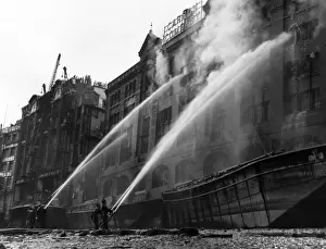 London firefighters at work with hosepipes