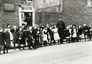 Schoolchildren Prints: London policeman helps schoolchildren cross the road