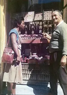 Lorna Holder talking to a shopkeeper outside jewellery shop